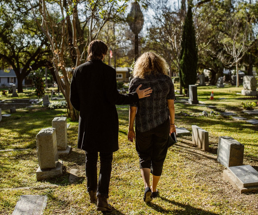 Family walking to visit a loved one's grave